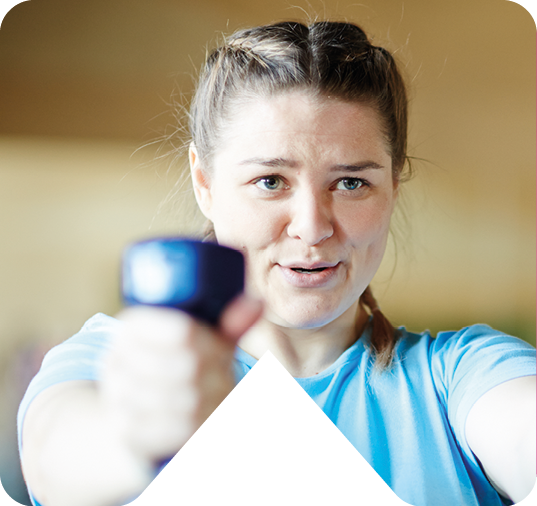 GIRL HOLDING DUMBELLS IN GYM