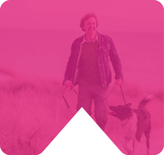 man walking dog on beach