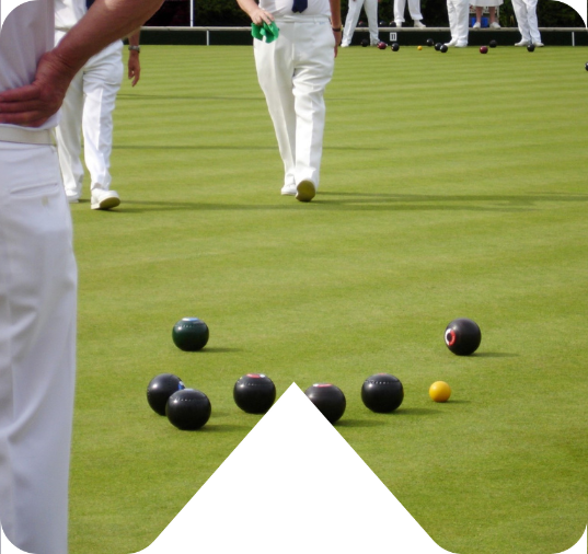 Bowlers playing bowls on a green.